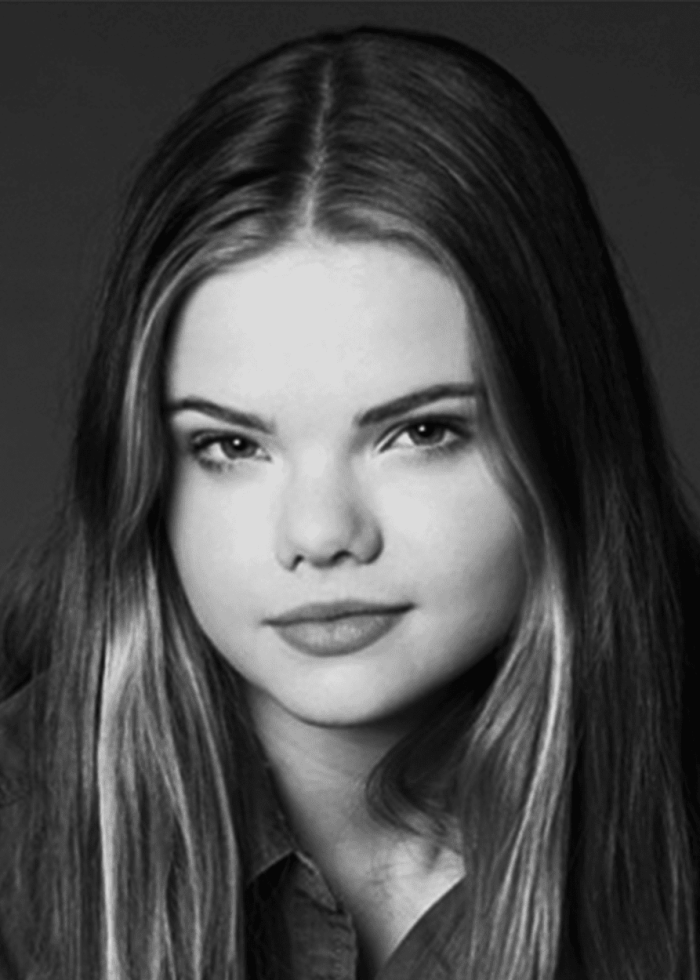 Katherine Reis portrait with long hair, looking at the camera.