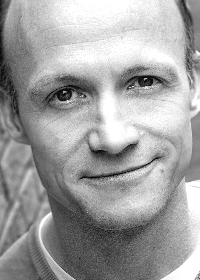 Richard-Hollis Close-up black and white portrait of a smiling man