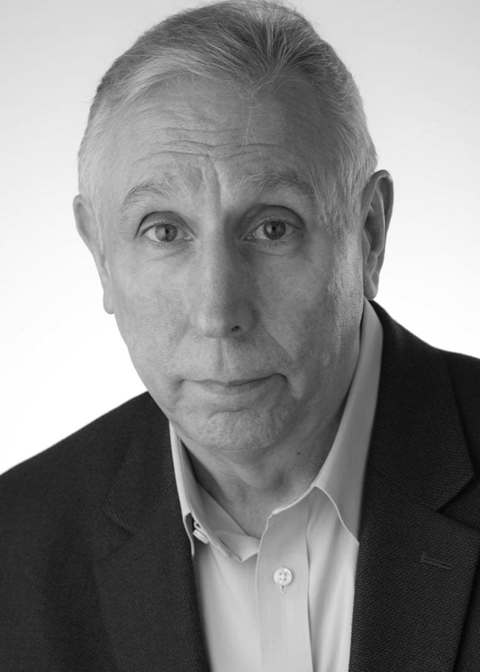 Rick Crom, headshot in a suit jacket, looking directly at the camera.