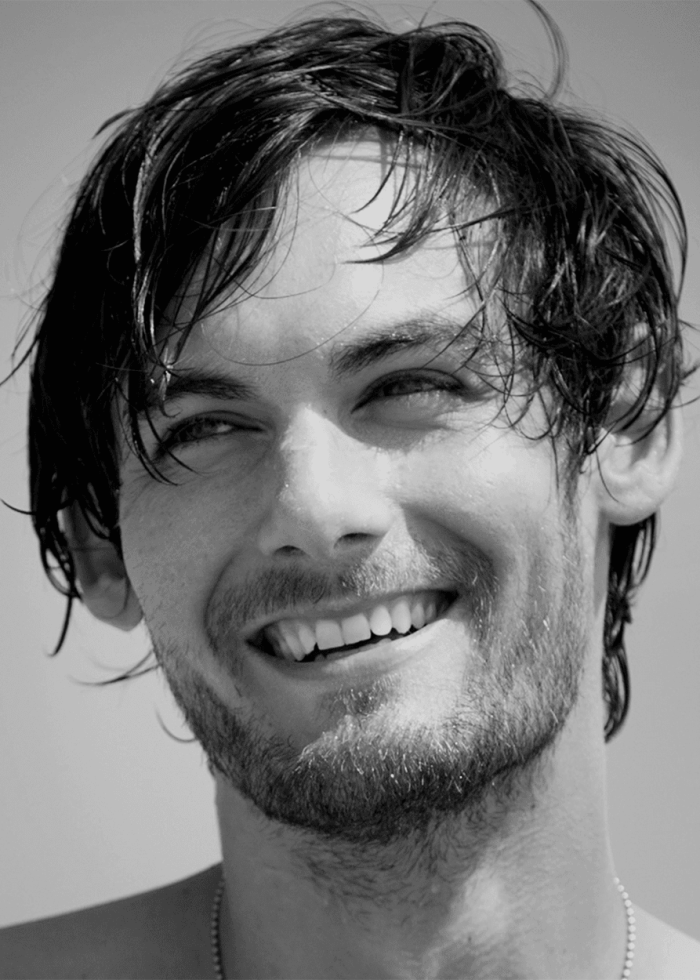 Smiling man with wet hair, portrait in black and white