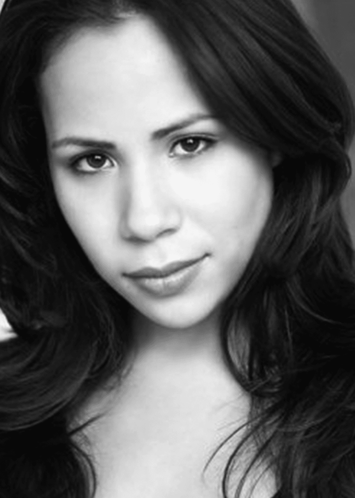 Rosal Colón, headshot of a woman with dark hair and a gentle smile.
