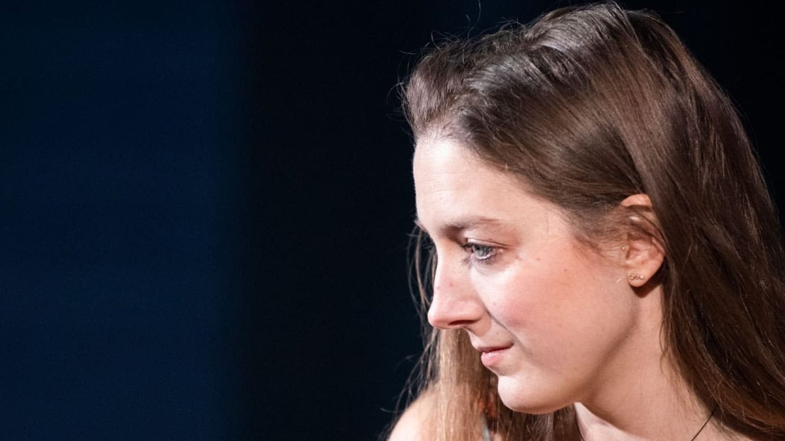 Woman in profile, looking thoughtful; a quiet moment.