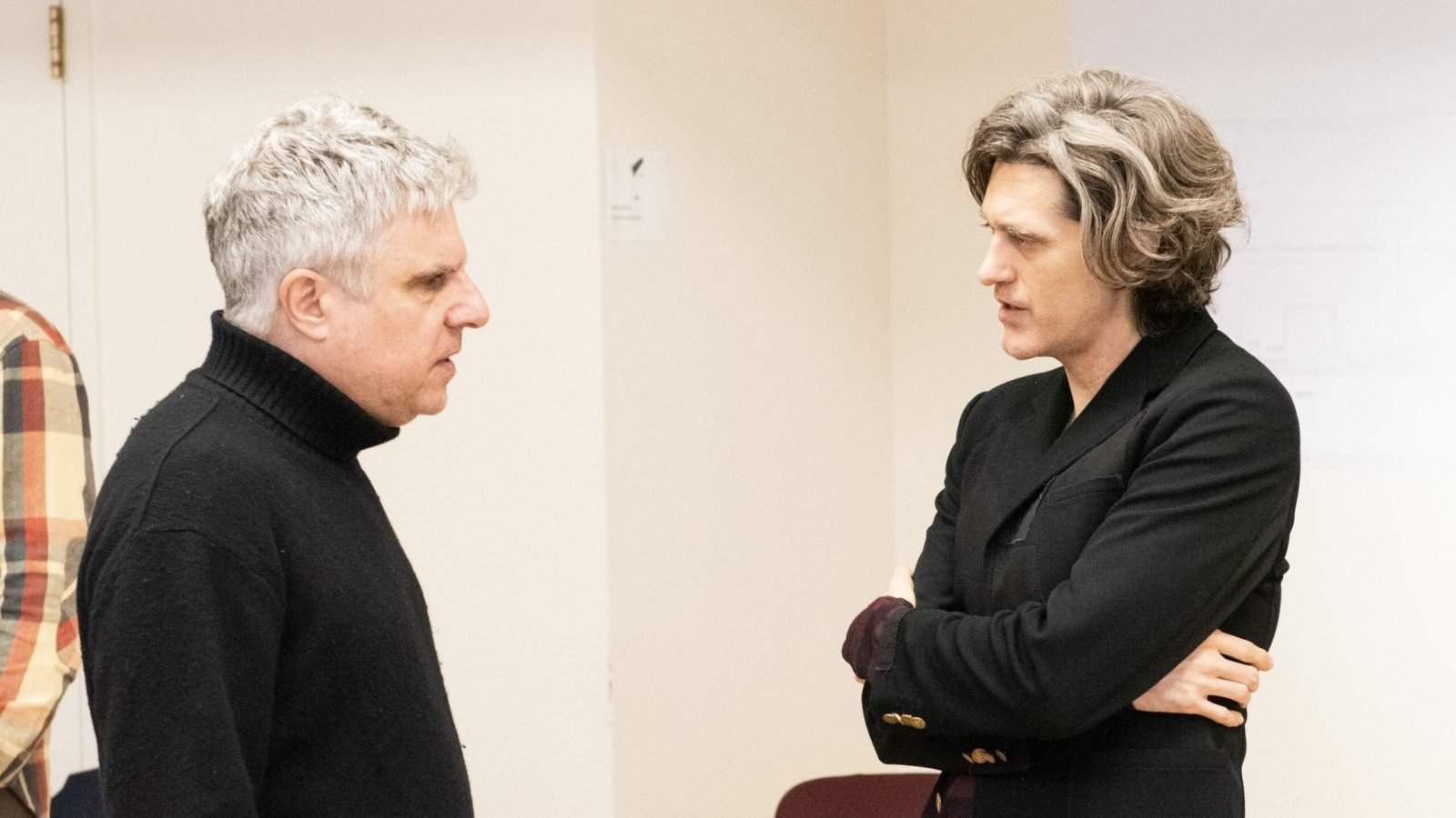 Two men in conversation, one with gray hair, the other with longer graying hair. A simulacrum of discussion.