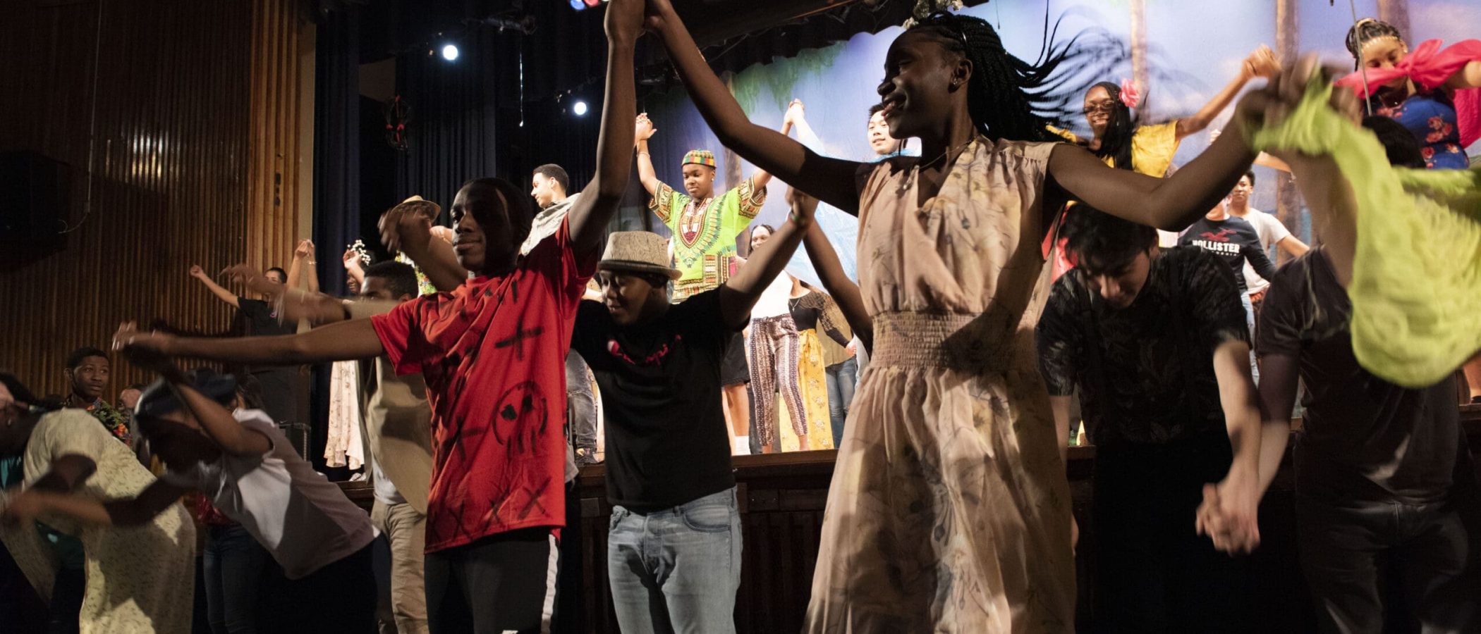 New York Music Photographer Dancers on stage holding hands and celebrating during a performance. Staging Success.