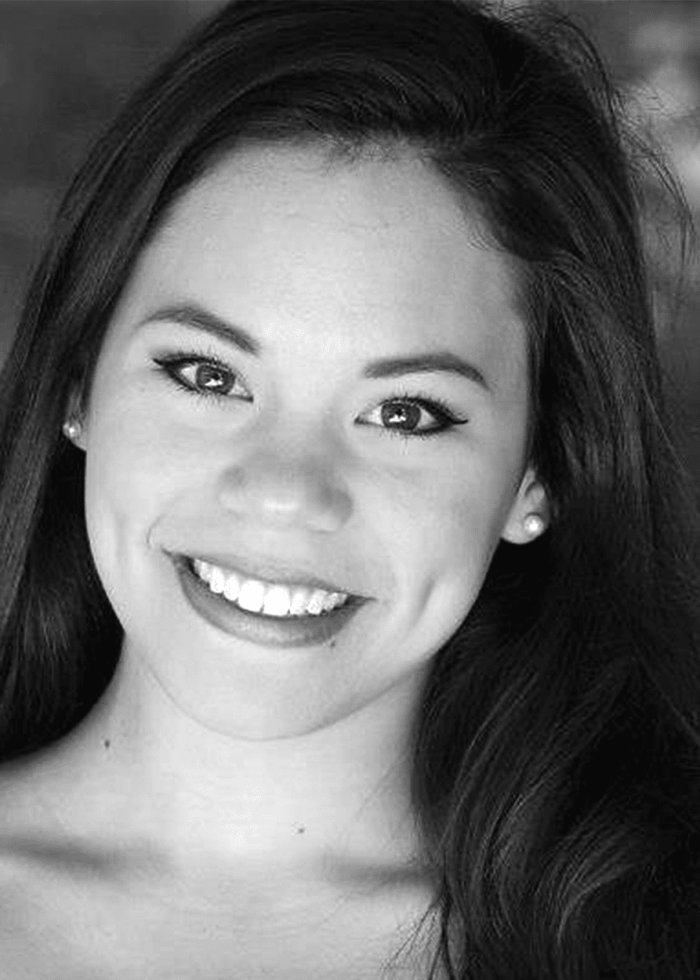 Smiling woman with dimples, in a black and white portrait.