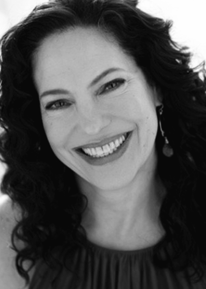 Giovanna Sardelli smiles, her dark curly hair framing her face.