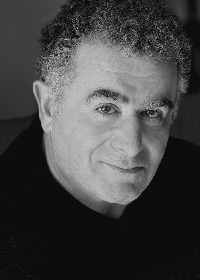 Saul Rubinek, actor, looking directly at the camera in black and white portrait.