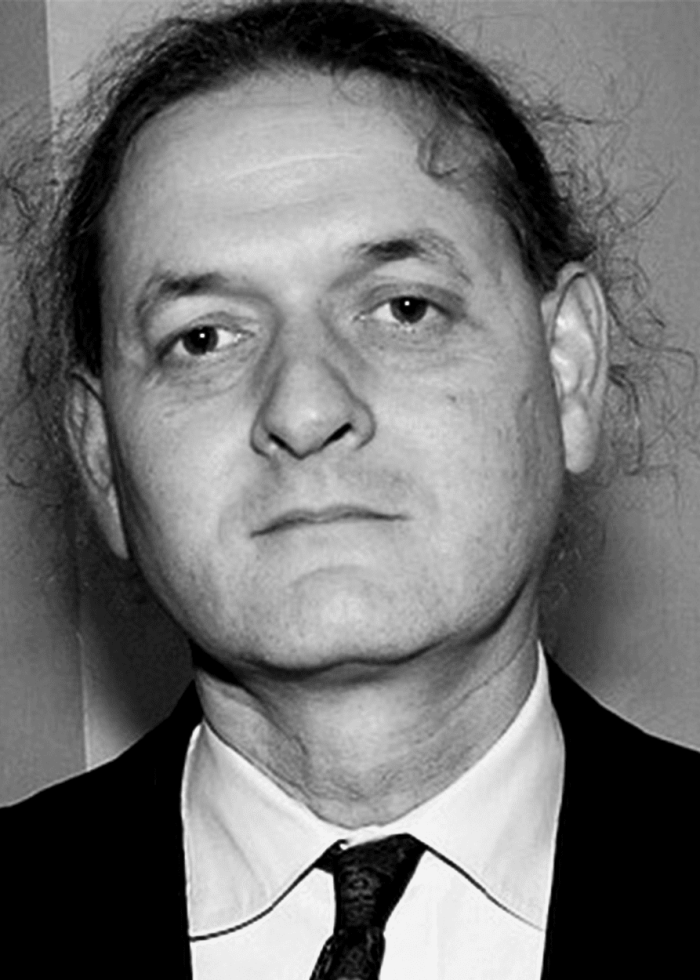 Scott Zigler in a black suit, looking directly at the camera.