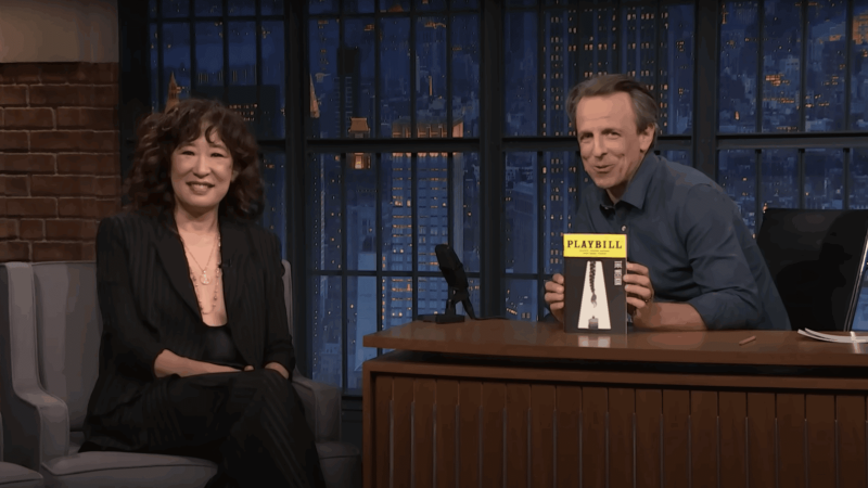 Sandra Oh and Seth Meyers on the Late Night set, with a Playbill for "The Welkin".