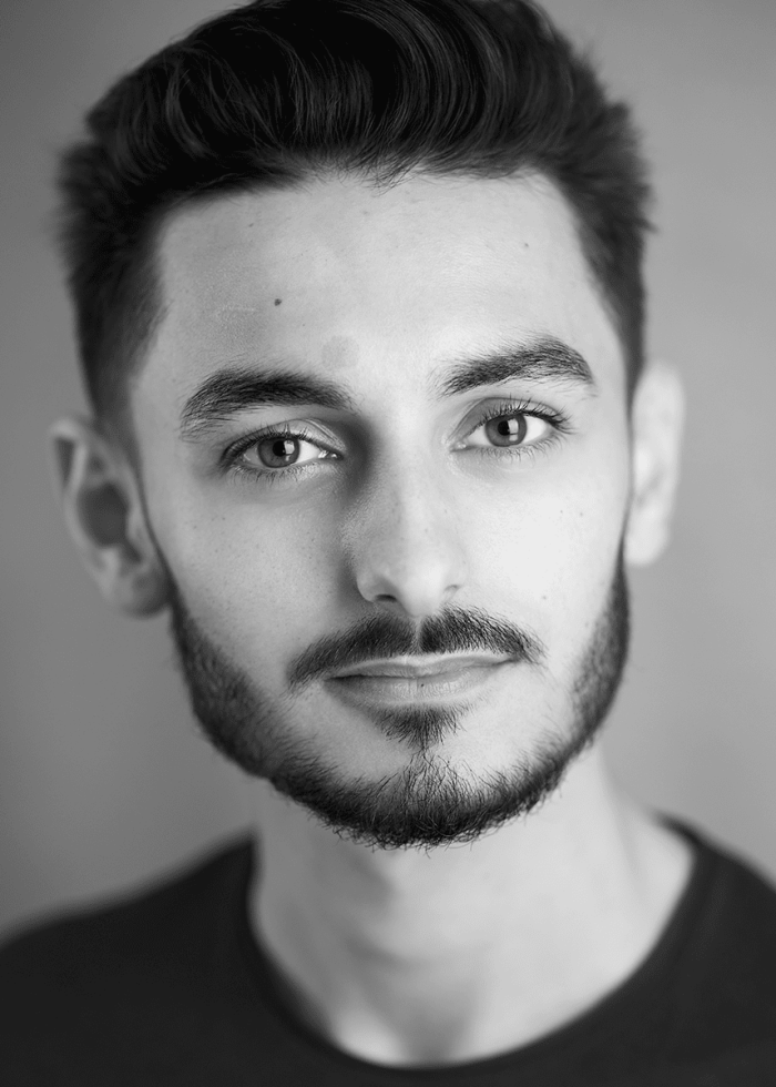 Omar Shafiuzzaman portrait: Man with dark hair and beard.