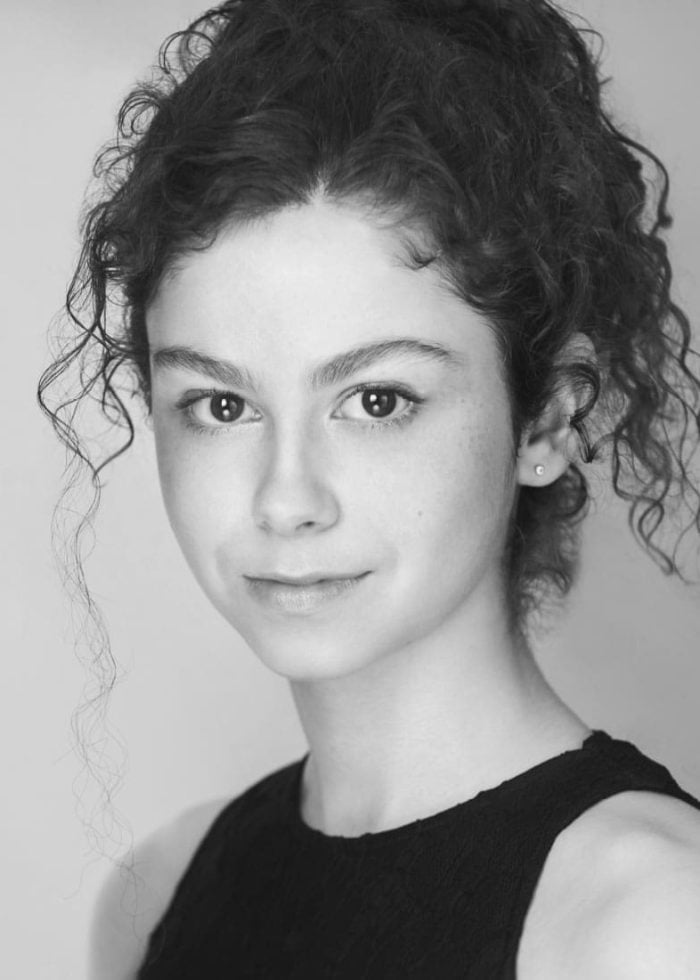 Skye Alyssa Friedman headshot, black and white portrait of a young woman with curly hair