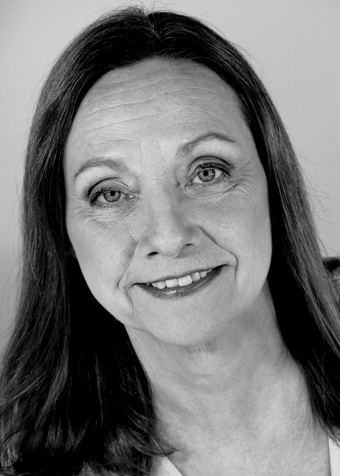 Dale Soules smiling in a black and white portrait