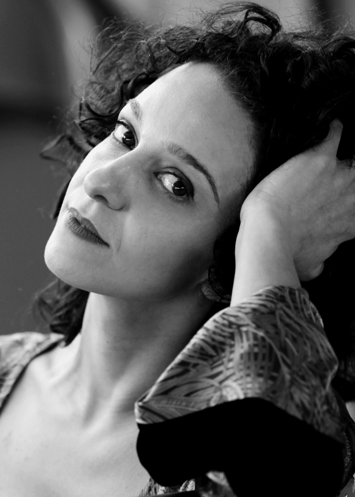 Cristina Spina portrait in black and white, looking thoughtfully at the camera.