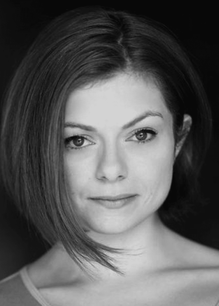 Headshot of Izzie Steele, actress with short, angled hair