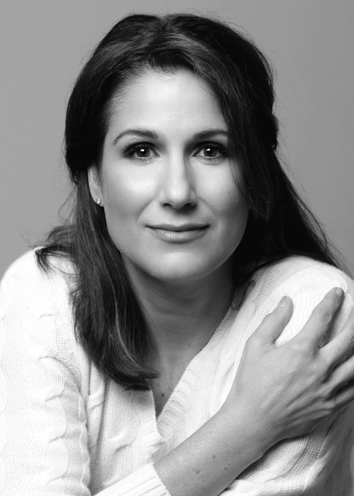 Stephanie J. Block looking at the camera, wearing a white sweater.