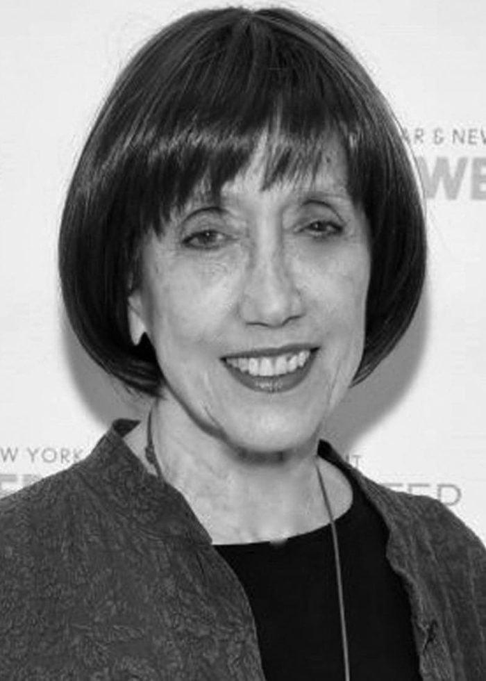 Susan Birkenhead smiling, wearing a dark jacket and bobbed hair