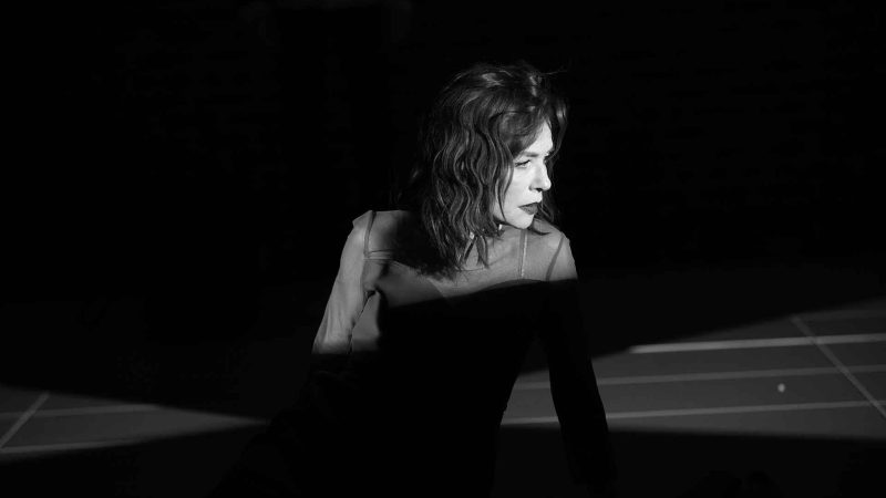 Actress in dramatic lighting, performing in a theater production from 2019.