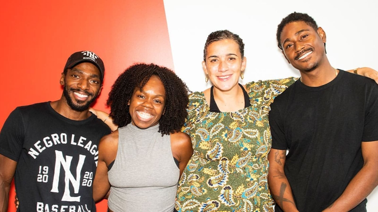 Four smiling people pose for a photo.