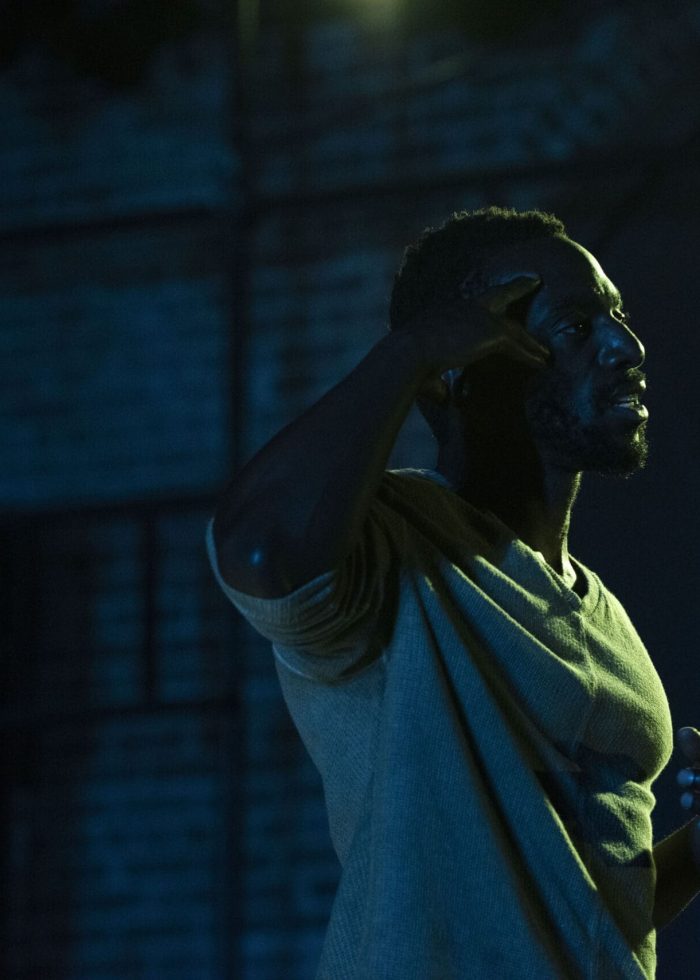 Actor in a play, The Last of the Love Letters, gesturing thoughtfully on stage.