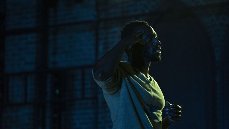 Actor in a play, The Last of the Love Letters, gesturing thoughtfully on stage.