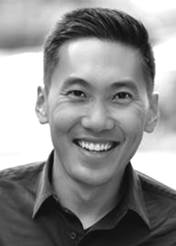 Smiling Asian man in black and white photo