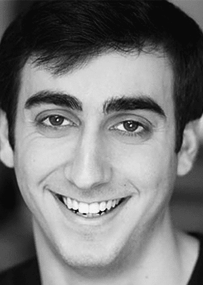 Daniel Tepper smiling, portrait in black and white