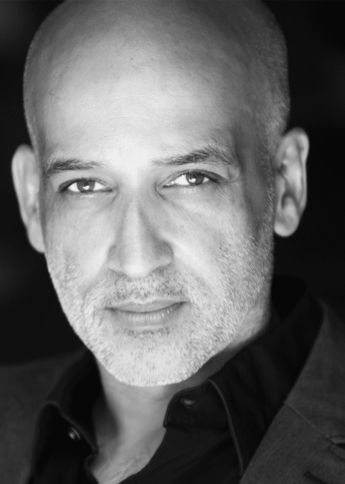 Alok Tewari, a bald man with a graying beard, looks directly at the camera.