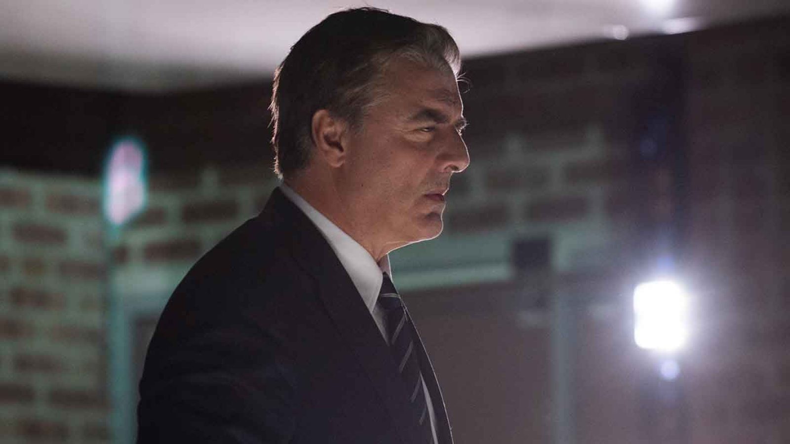 Serious-looking man in a dark suit