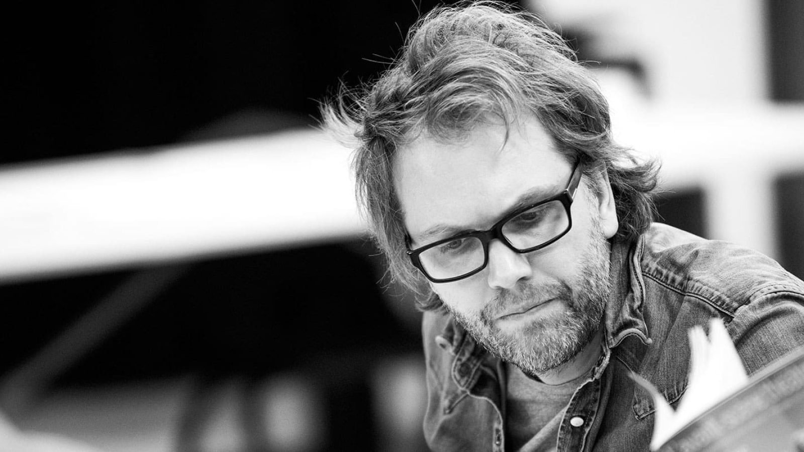 Man with glasses looking at papers