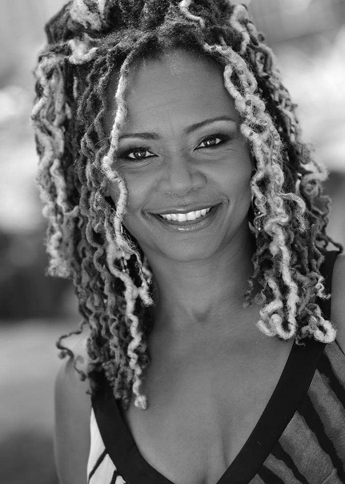 Tonya Pinkins smiling at the camera, showcasing her beautiful dreadlocks
