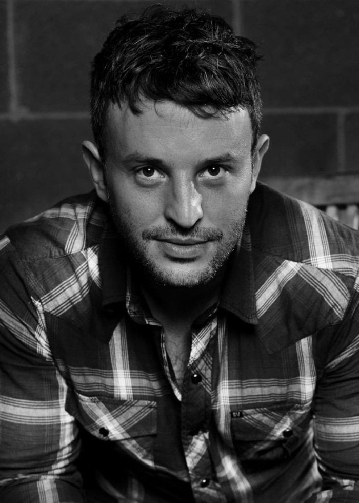 Trip Cullman: Man in plaid shirt looking at the camera.