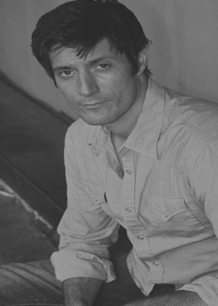 Gareth Saxe looking at the camera, wearing a button-down shirt.