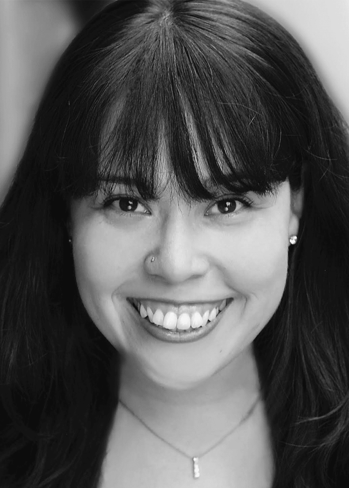 Smiling woman with dark hair and a nose ring