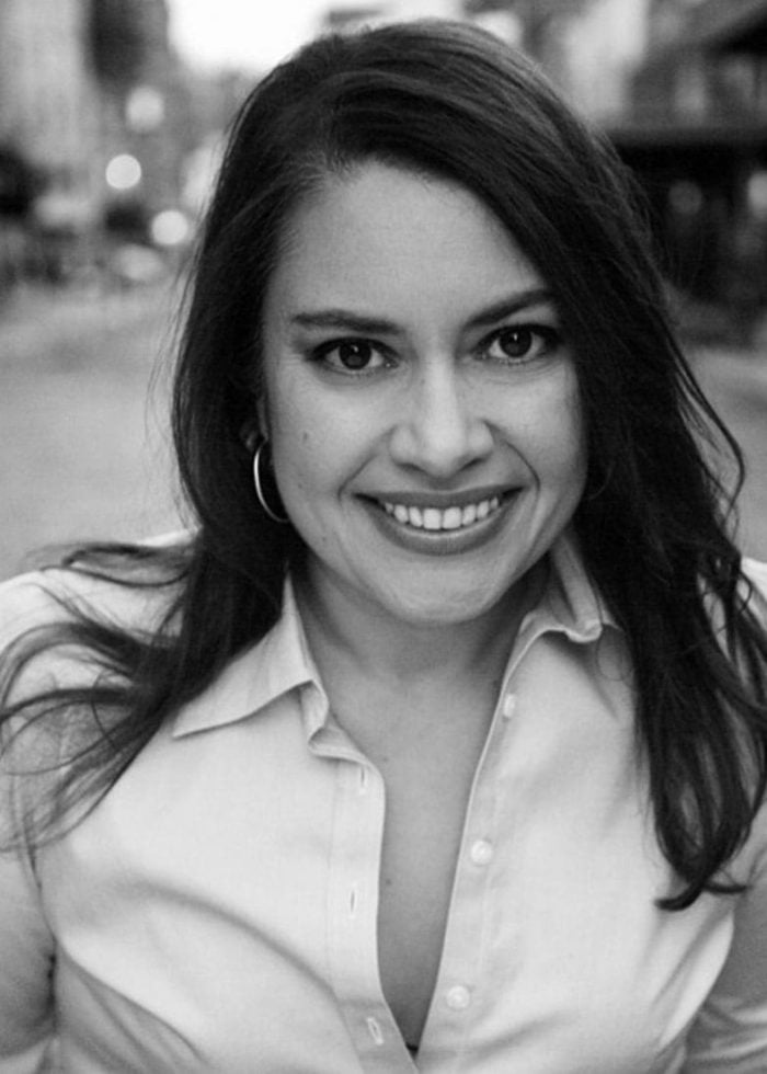 Vanessa Aspillaga smiling in black and white