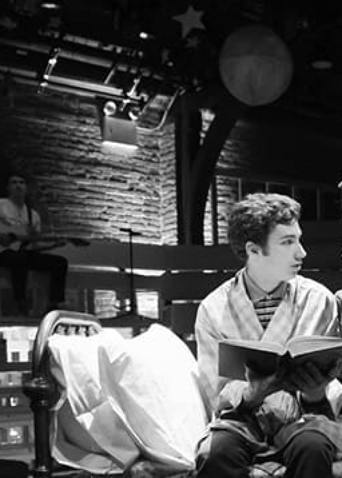 Actors performing in a play with musicians in the background. Spare Times for Children performance.