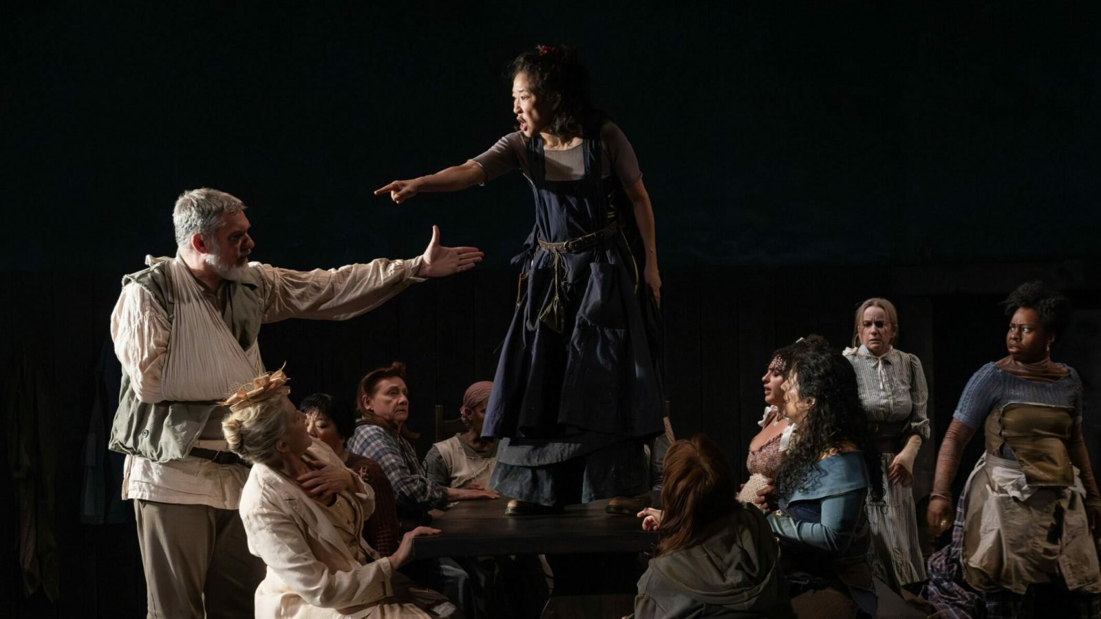 A dramatic scene from the play, *The Welkin*, shows actors in period costumes engaged in a tense confrontation.