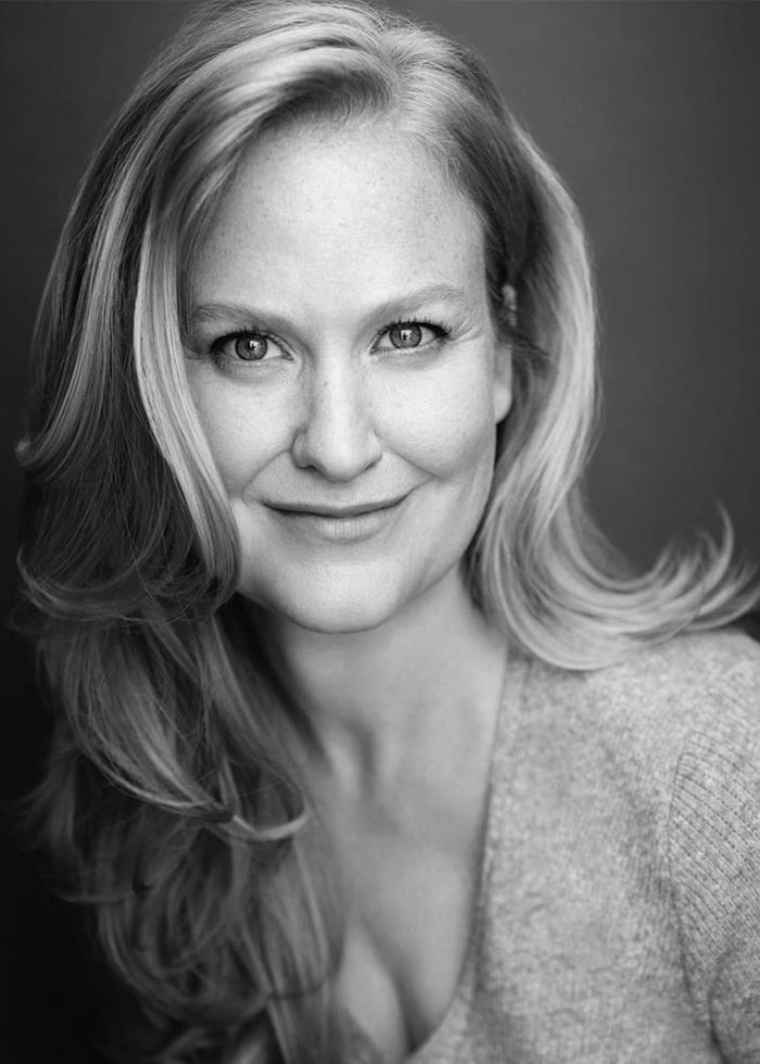 Heidi Armbruster, blonde woman with a gentle smile, looking at the camera.