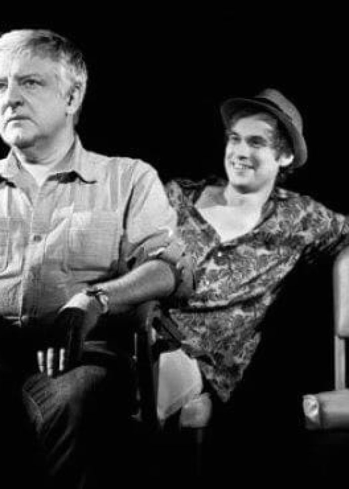 Two actors from the "Bluebird" play at the Atlantic Theater in New York, one seated, one leaning.