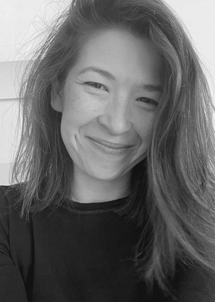 Daria Miyeko Marinelli smiling at the camera with long hair