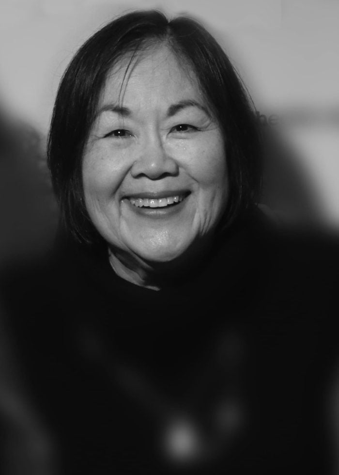 Emily Kuroda smiles in a black and white portrait
