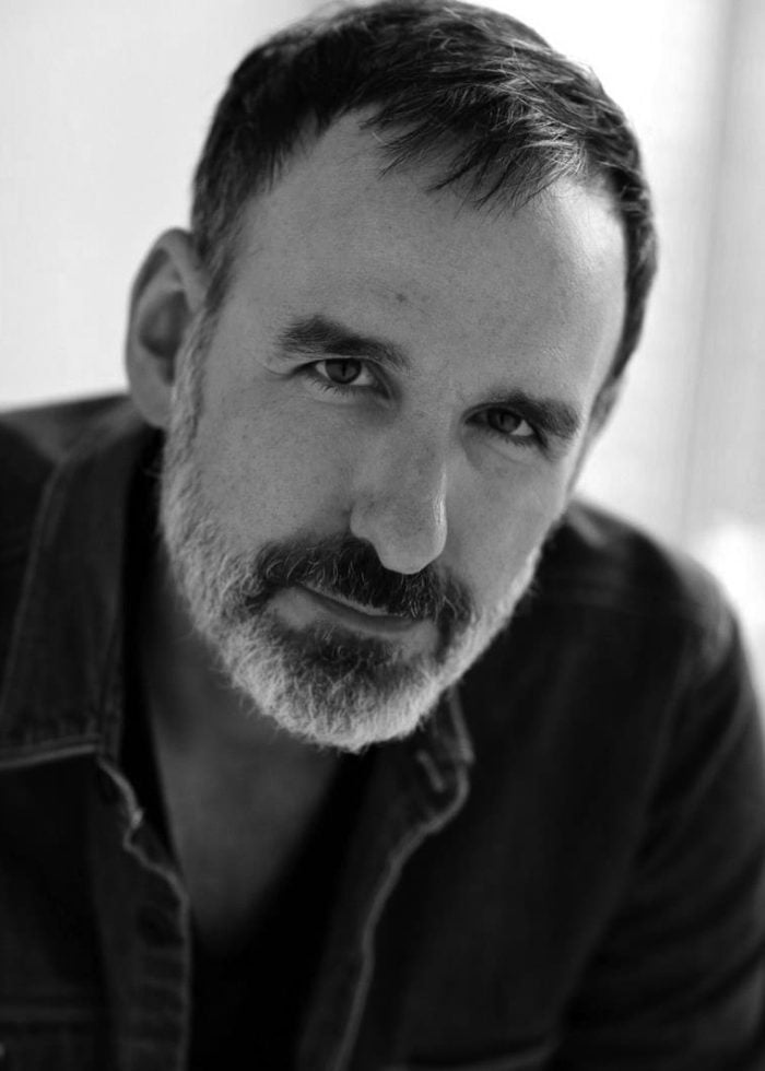 Close-up portrait of Erik Lochtefeld, looking directly at the camera with a thoughtful expression.
