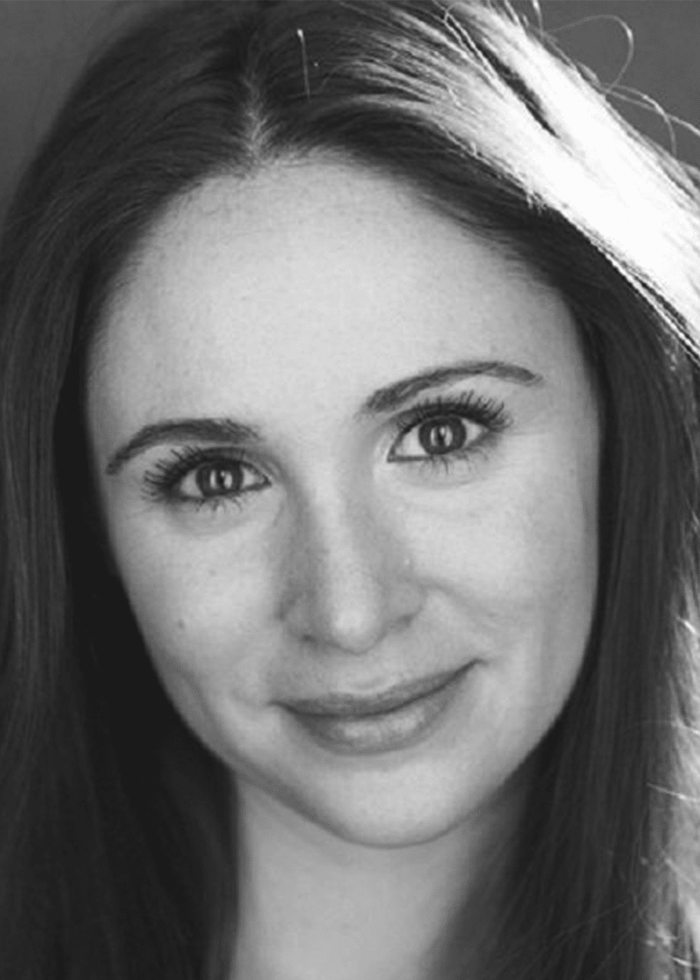 Headshot of Faye Rex, smiling with dark hair and eyes