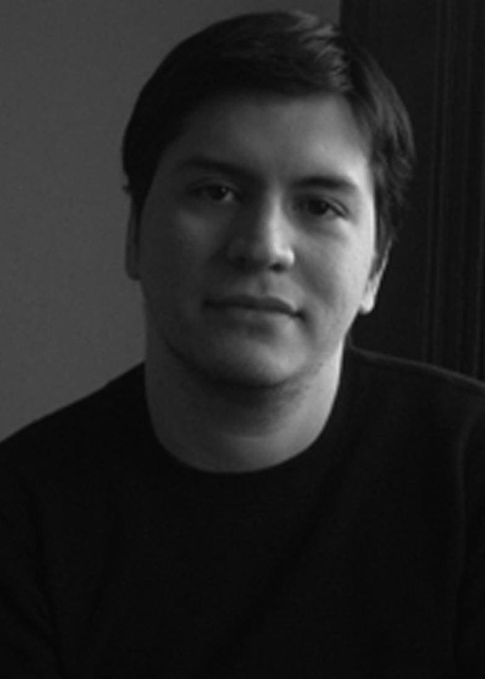 Jaime Castañeda looking directly at the camera in a black and white portrait.