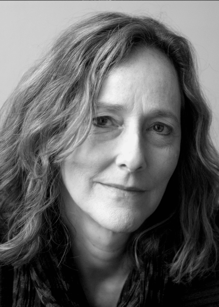 Portrait of Jo Bonney, looking directly at the camera in black and white.