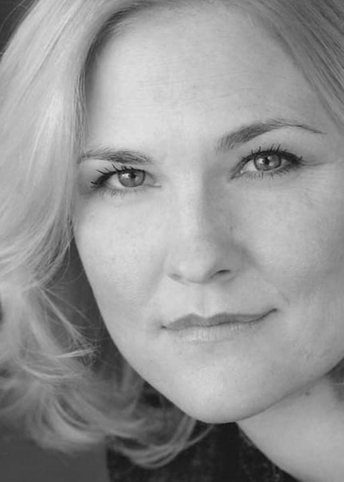 Kelly McAndrew, actress, in a black and white headshot