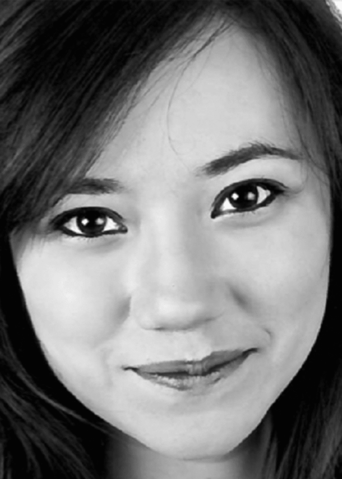 Close-up portrait of Mara Measor, smiling, looking directly at the viewer