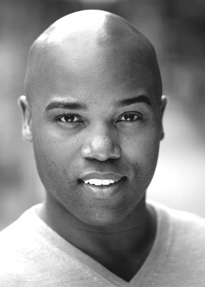 Melvin Tunstall III, smiling portrait in black and white