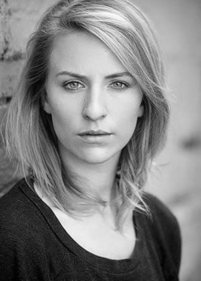 Mickey Sumner in a black and white headshot, looking directly at the camera.