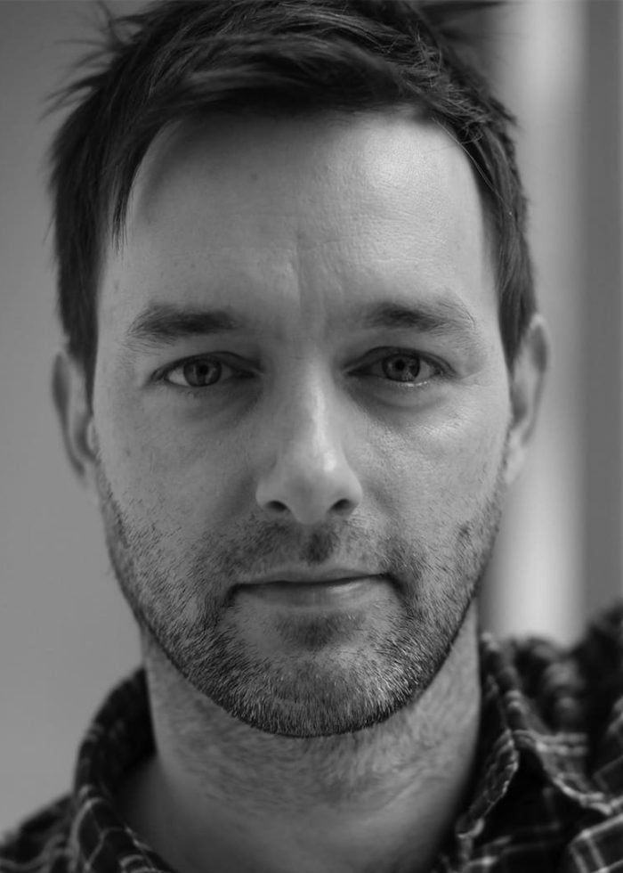 Close-up portrait of Jesse Pennington, a man with short dark hair and a beard.