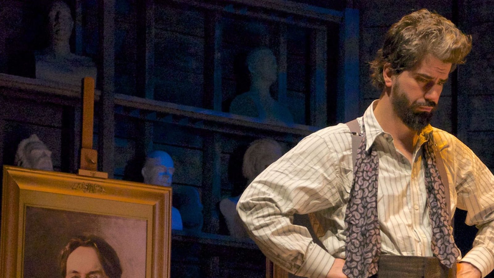 A pensive artist, dressed in period attire, stands in his studio, surrounded by busts and paintings. His expression suggests contemplation of his art's posterity.